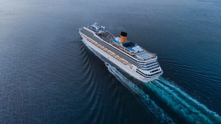 aerial view of beautiful white cruise ship above luxury cruise c